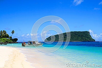 Polynesian fisherman boat dock on white golden sandy Lalomanu beach at tropical paradise in Pacific Ocean Upolu Island Stock Photo